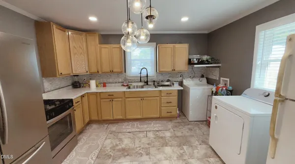 a kitchen with a sink stove and cabinets