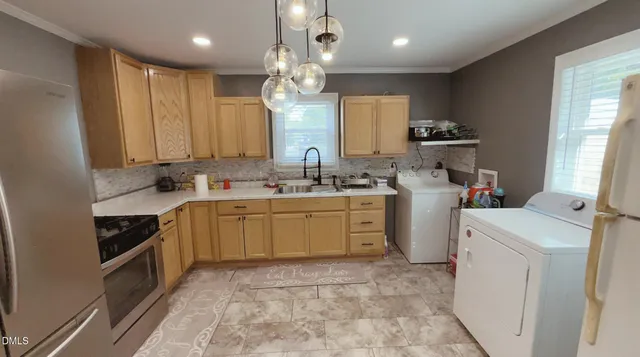 a kitchen with a sink stove and cabinets