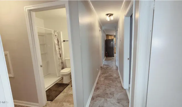 a view of a bathroom from a corridor