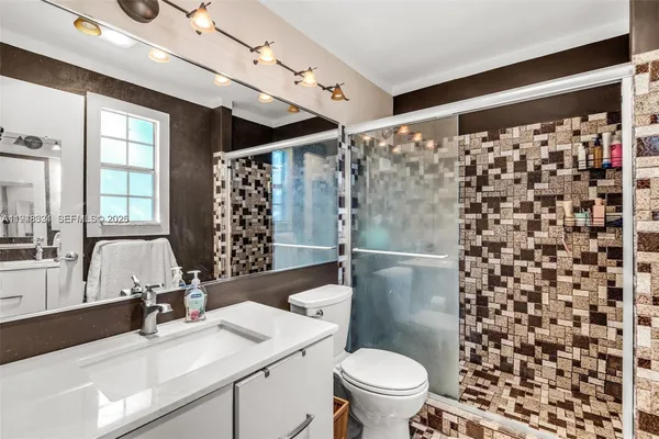 a bathroom with a sink toilet and shower