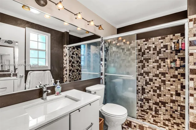 a bathroom with a sink toilet and shower