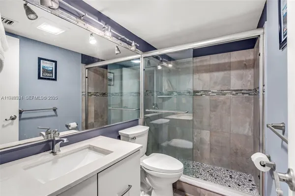 a bathroom with a sink toilet and shower