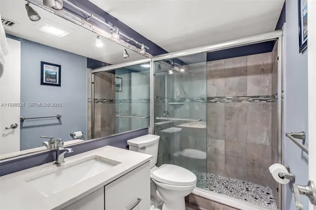 a bathroom with a sink toilet and shower