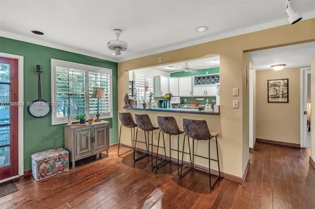 a very nice looking living room with wooden floor and furniture