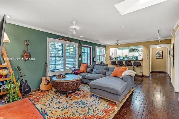 a living room with furniture a rug and a large window