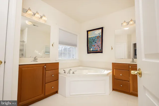 a room with a baby bed dresser and a window