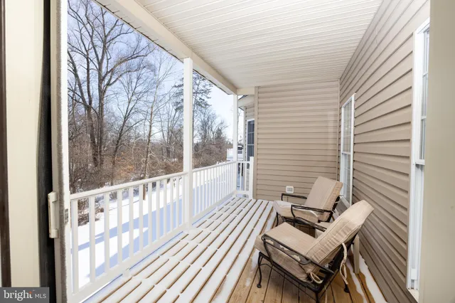 a view of two chairs in the balcony