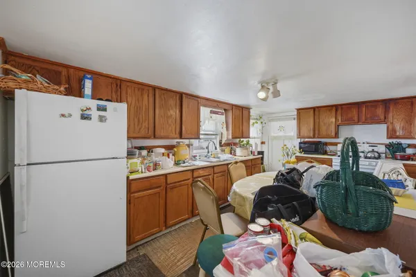 a kitchen with a refrigerator and a sink