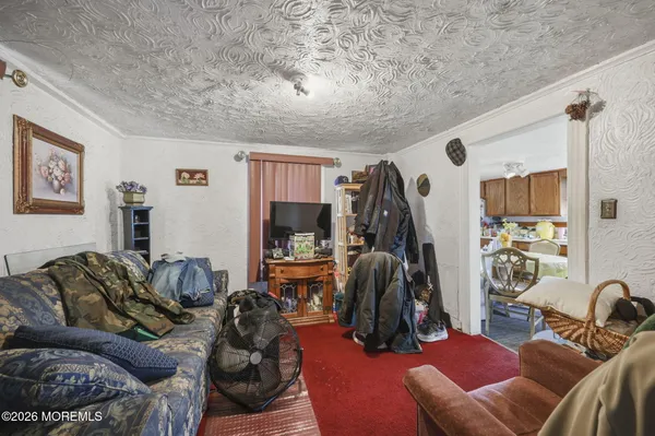 a living room with furniture ceiling fan and a window