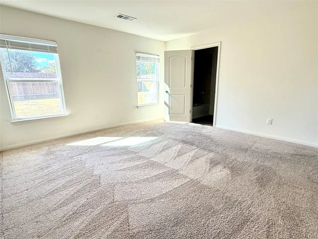 a view of a livingroom with a ceiling fan and window