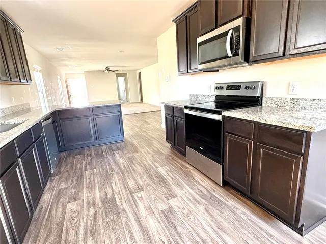 a view of kitchen with wooden floor