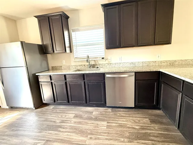 a kitchen with stainless steel appliances granite countertop a stove a microwave and a sink