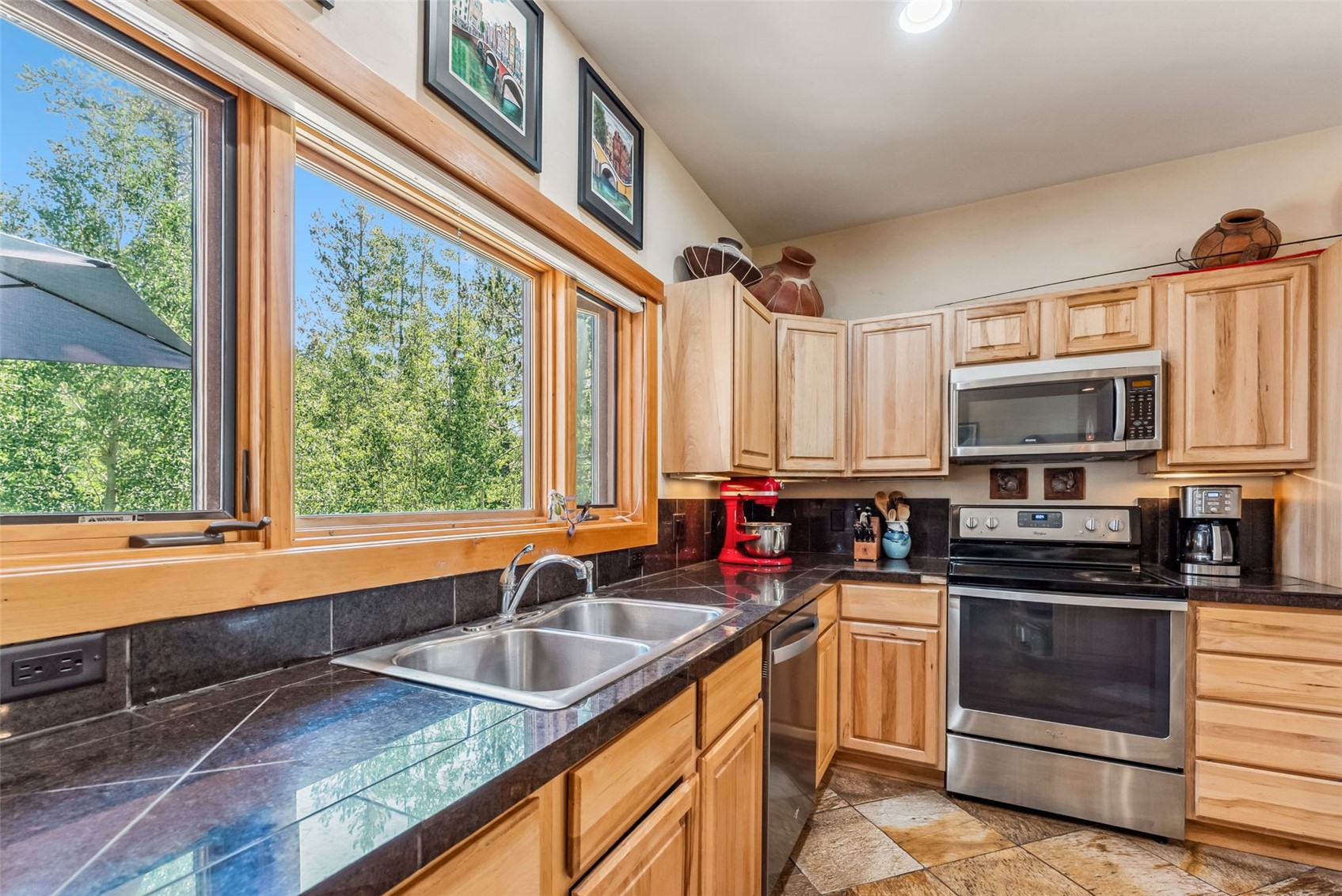 228 Glacier Ridge Road Alma, CO 80420 - Photo 8 of 50 a kitchen with stainless steel appliances a sink a stove and cabinets