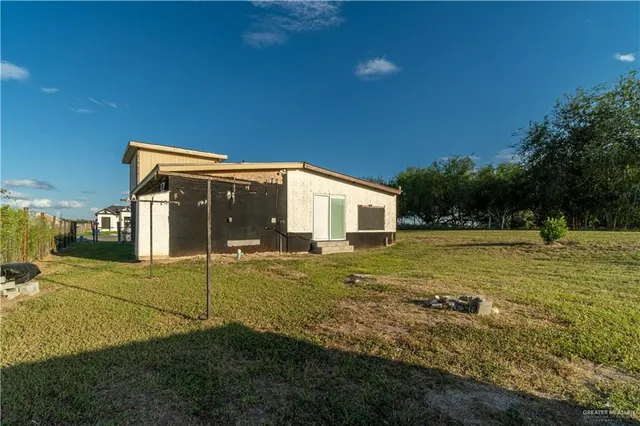 a view of a house with backyard and pool