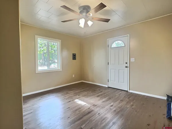 wooden floor in an empty room with a window
