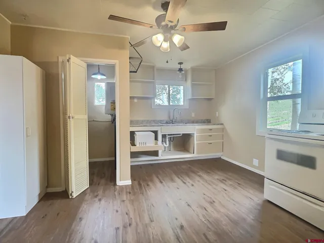a view of a kitchen with a dishwasher cabinets and wooden floor