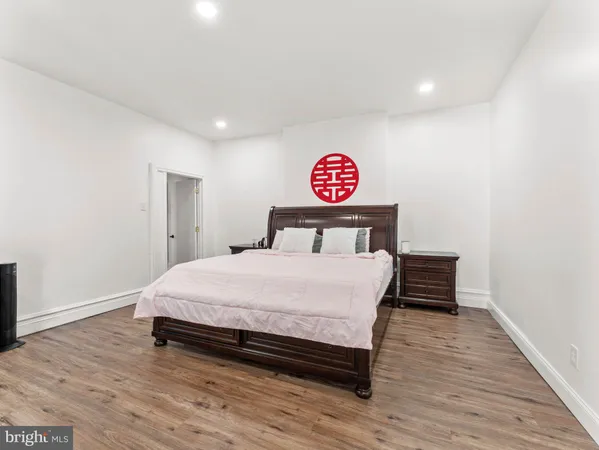 a bedroom with a bed and a wooden floor