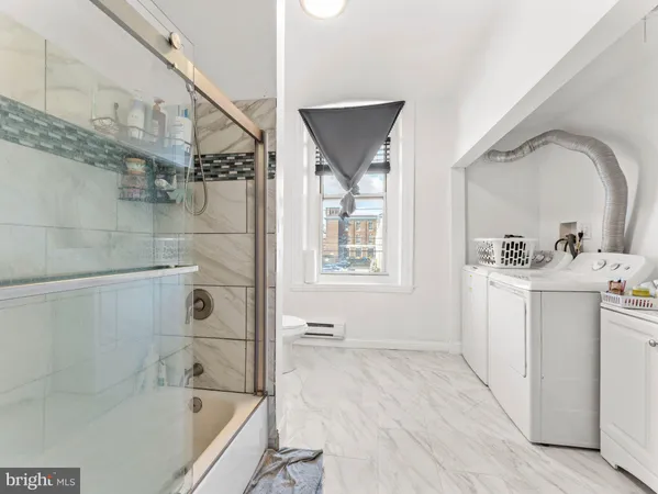 a bathroom with a bathtub a sink and a window
