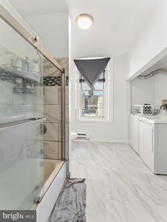 a bathroom with a tub a sink and a shower