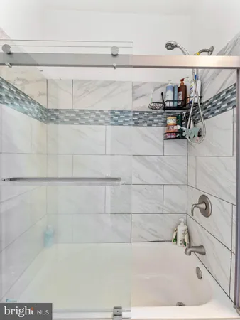 a bathroom with a bathtub and shower