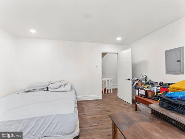 a bedroom with furniture and a wooden floor