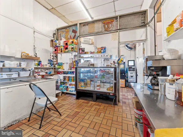 a utility room with lots of wooden furniture and refrigerator