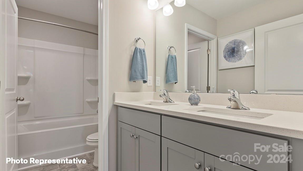308 Streamwood Road Troutman, NC 28166 - Photo 13 of 39 a bathroom with a tub a sink and a mirror