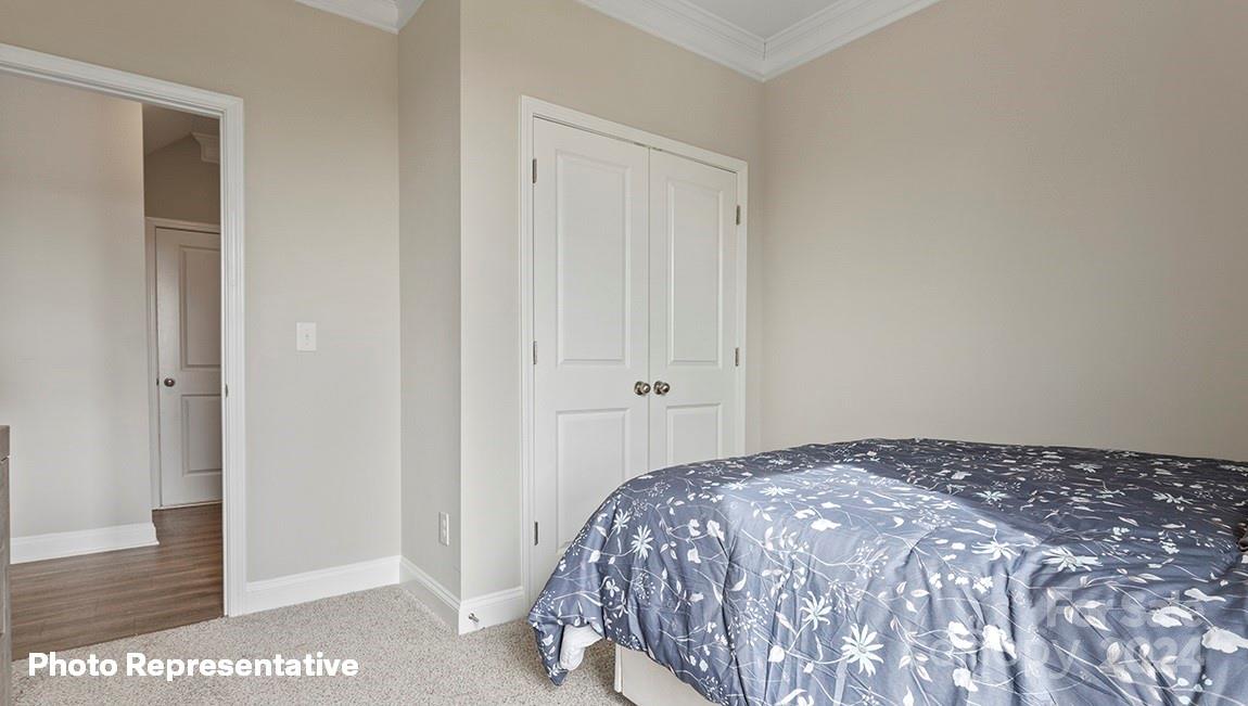 308 Streamwood Road Troutman, NC 28166 - Photo 16 of 39 a bedroom with a bed and a rug