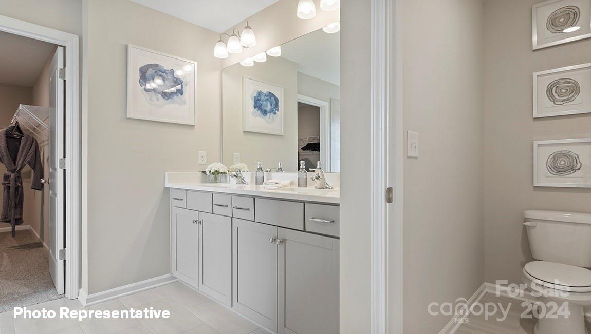 308 Streamwood Road Troutman, NC 28166 - Photo 23 of 39 a bathroom with a granite countertop sink a toilet and a mirror