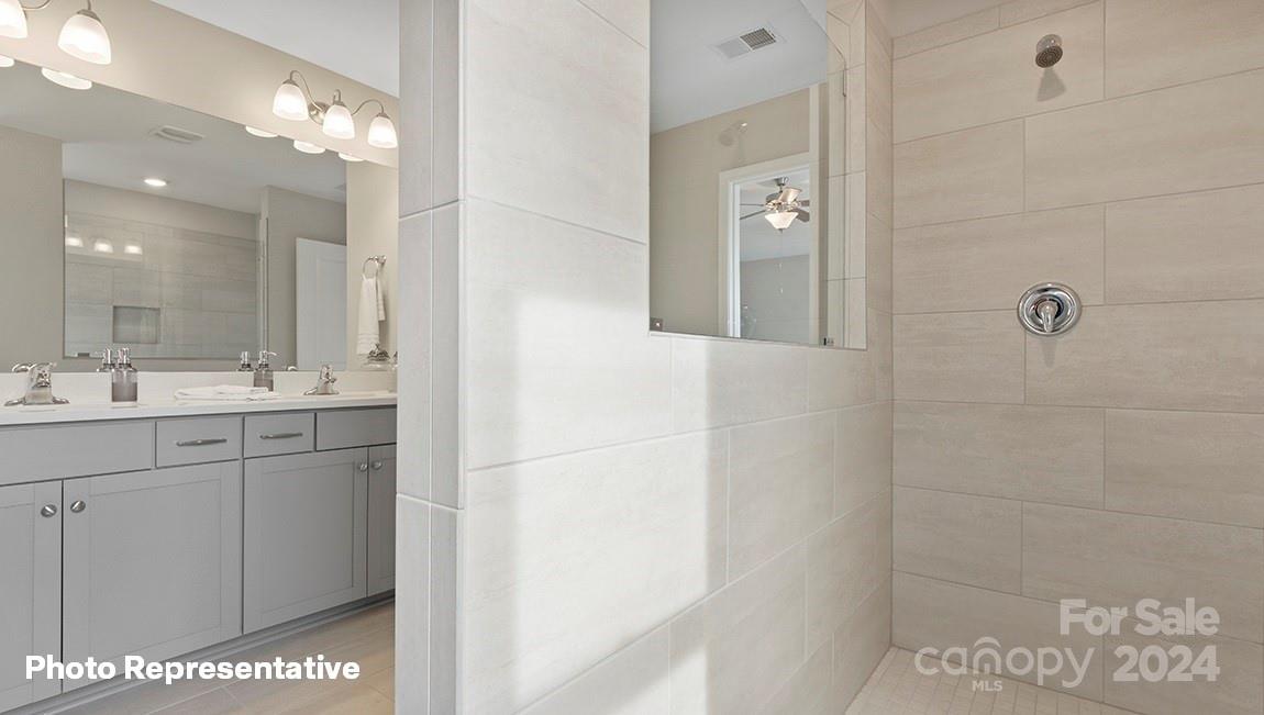 308 Streamwood Road Troutman, NC 28166 - Photo 24 of 39 a bathroom with a double vanity sink a mirror and shower