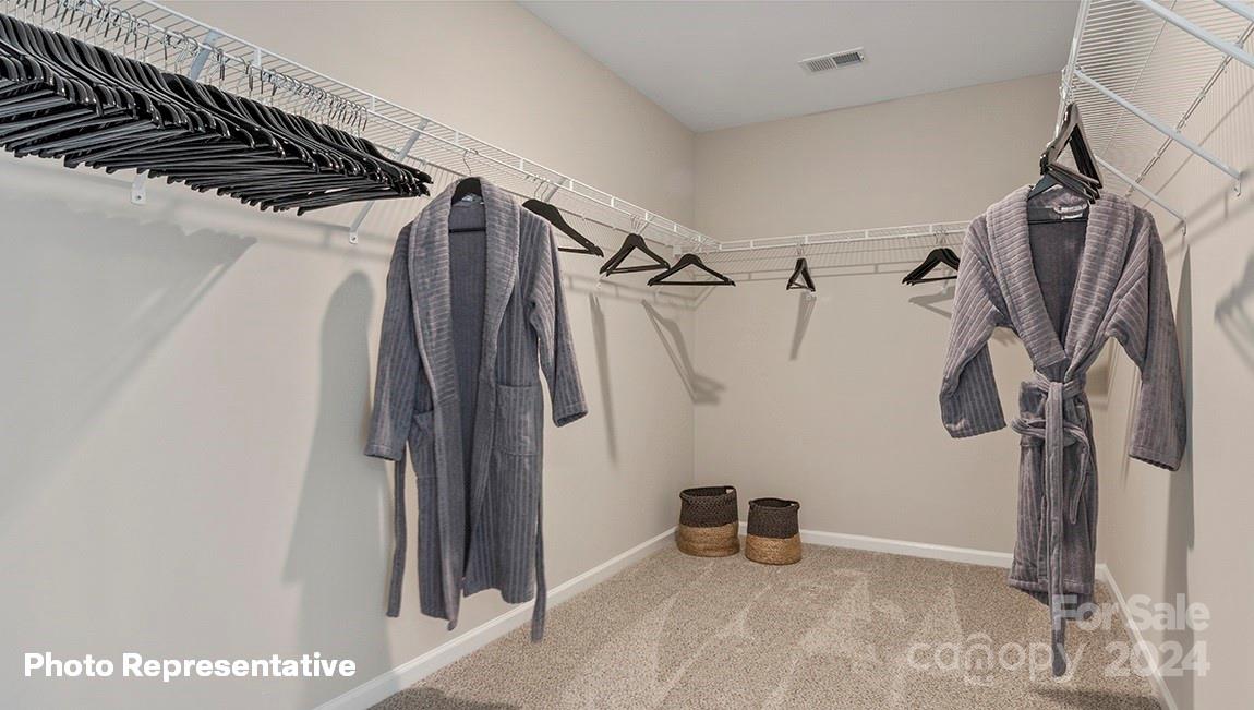 308 Streamwood Road Troutman, NC 28166 - Photo 28 of 39 a view of walk in closet with clothes and shoes