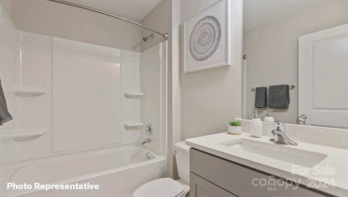 308 Streamwood Road Troutman, NC 28166 - Photo 10 of 39 a bathroom with a granite countertop sink a toilet and shower