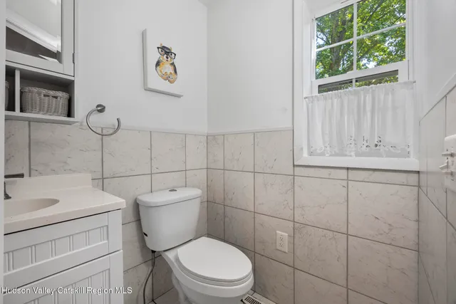 a white toilet sitting next to a bathroom sink