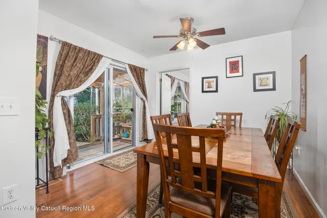 a view of a dining room with furniture window and wooden floor