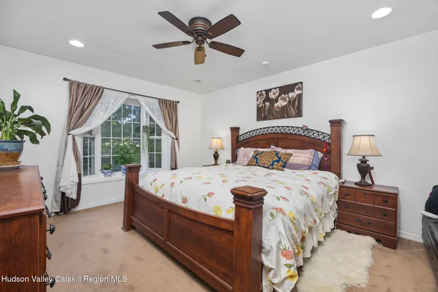a bedroom with a large bed and a chandelier