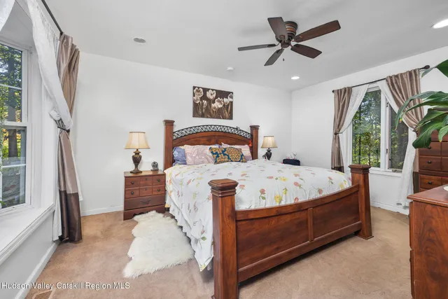 a bed sitting in a bedroom next to a window