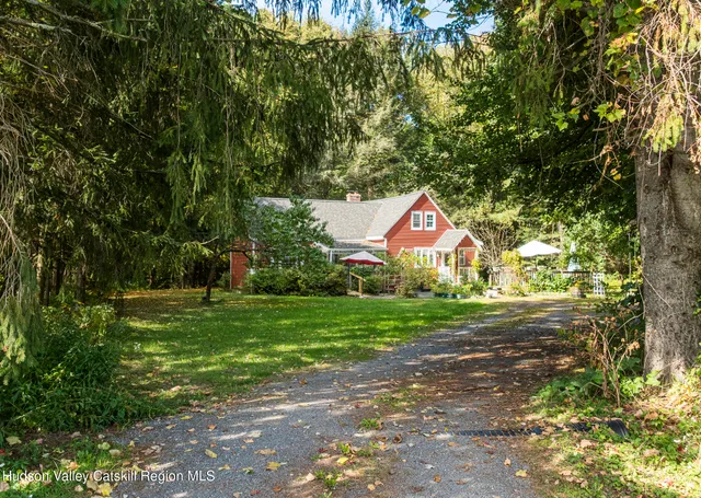 a front view of a house with yard and green space