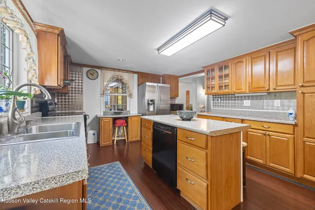 a kitchen with stainless steel appliances granite countertop a sink stove and cabinets