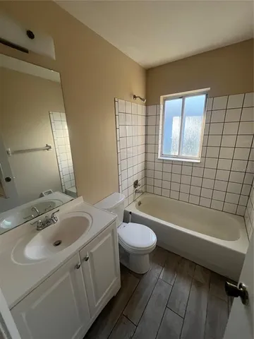 a bathroom with a sink a toilet and bathtub