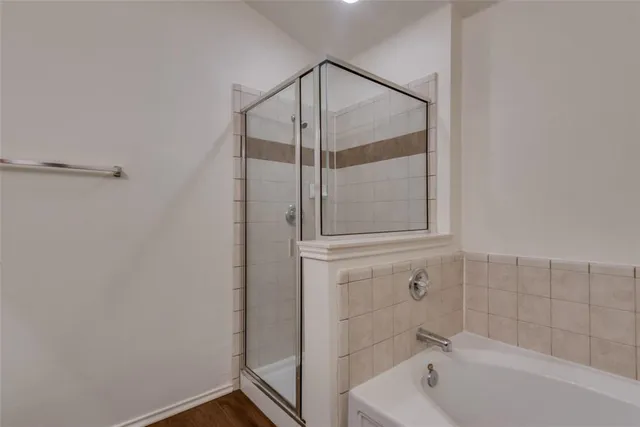 a bathroom with a bathtub and shower
