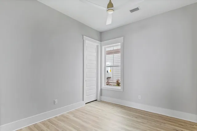 a backyard of a house with a fountain and a large tree