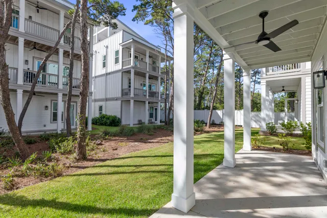 a view of kitchen with kitchen island wooden floor and living room