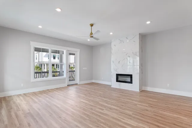 a kitchen island with stainless steel appliances kitchen island a table chairs in it and wooden floors