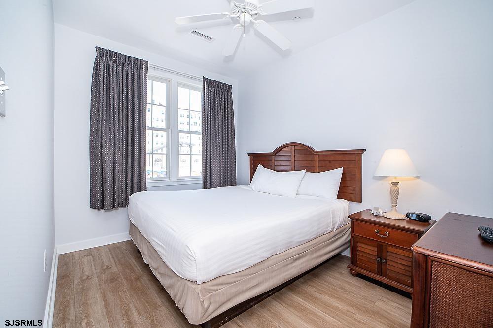 1001 Little Atlantic Avenue, Unit 373 Ocean City, NJ 08226 - Photo 12 of 27 a large bed sitting in a bedroom next to a window