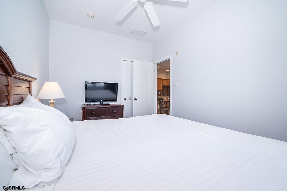 1001 Little Atlantic Avenue, Unit 373 Ocean City, NJ 08226 - Photo 13 of 27 a bedroom with a bed and a television