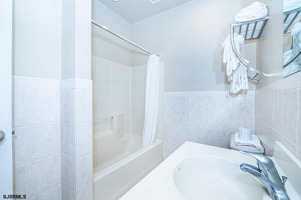 1001 Little Atlantic Avenue, Unit 373 Ocean City, NJ 08226 - Photo 14 of 27 a bathroom with a bathtub and shower
