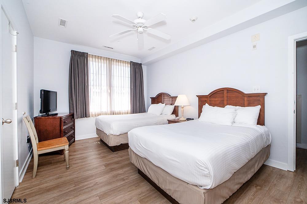 1001 Little Atlantic Avenue, Unit 373 Ocean City, NJ 08226 - Photo 18 of 27 a bedroom with bed and a chair