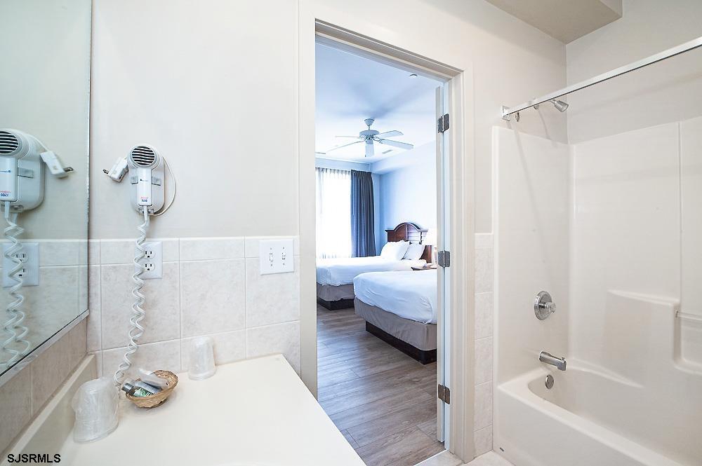 1001 Little Atlantic Avenue, Unit 373 Ocean City, NJ 08226 - Photo 24 of 27 a bathroom with a tub sink and mirror