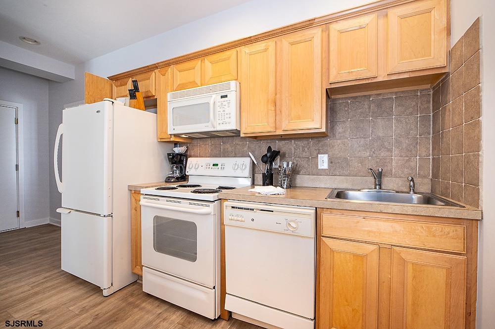 1001 Little Atlantic Avenue, Unit 373 Ocean City, NJ 08226 - Photo 3 of 27 a white refrigerator freezer sitting inside of a kitchen