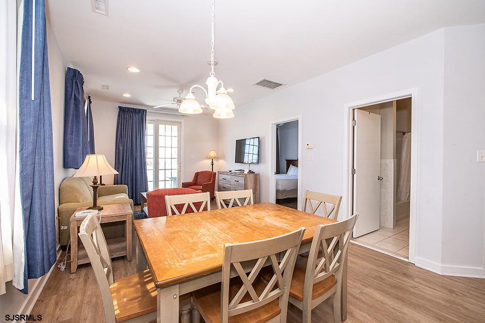 1001 Little Atlantic Avenue, Unit 373 Ocean City, NJ 08226 - Photo 6 of 27 a view of a dining room with furniture and wooden floor